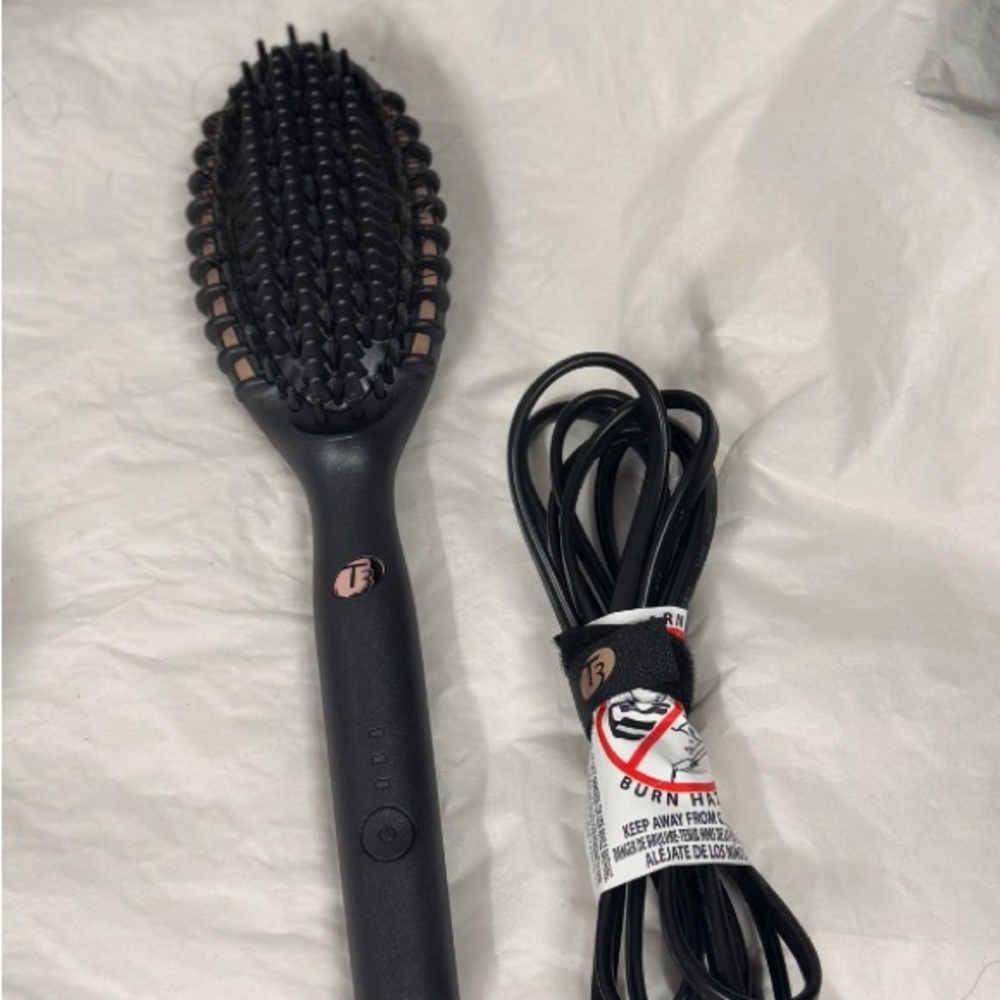 Black rose gold T3  heated Styling Brush 
Gets hot enough for the thickest hair